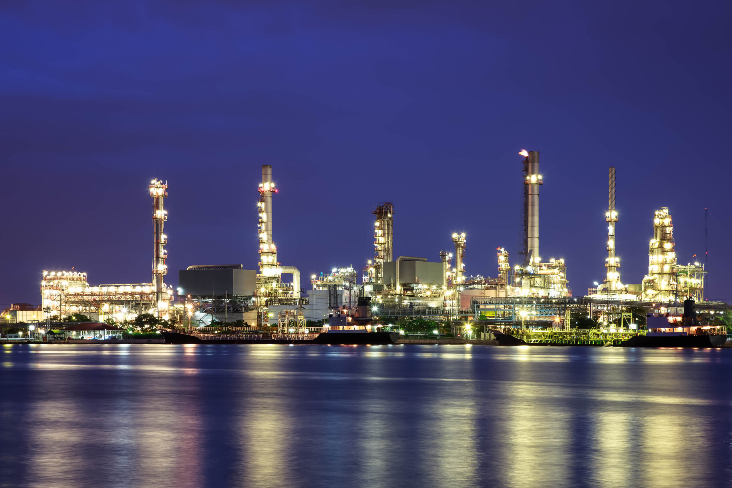 Oil refinery at twilight with reflection